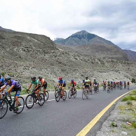 In this picture taken on June 27, 2019, Pakistani and international cyclists take part in Tour de Khunjrab cycling race on Karakaram highway, near Pakistan's northern Gilgit city. - One of the world's highest altitude cycling competitions will take place in Pakistan from June 27 to June 30. More than 70 Pakistani and international cyclists are set to take part in the Tour de Khunjerab 2019 in Pakistan's Gilgit-Baltistan region near the Chinese border. (Photo by AAMIR QURESHI / AFP)